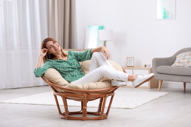 Photo of Attractive young woman resting in armchair at home