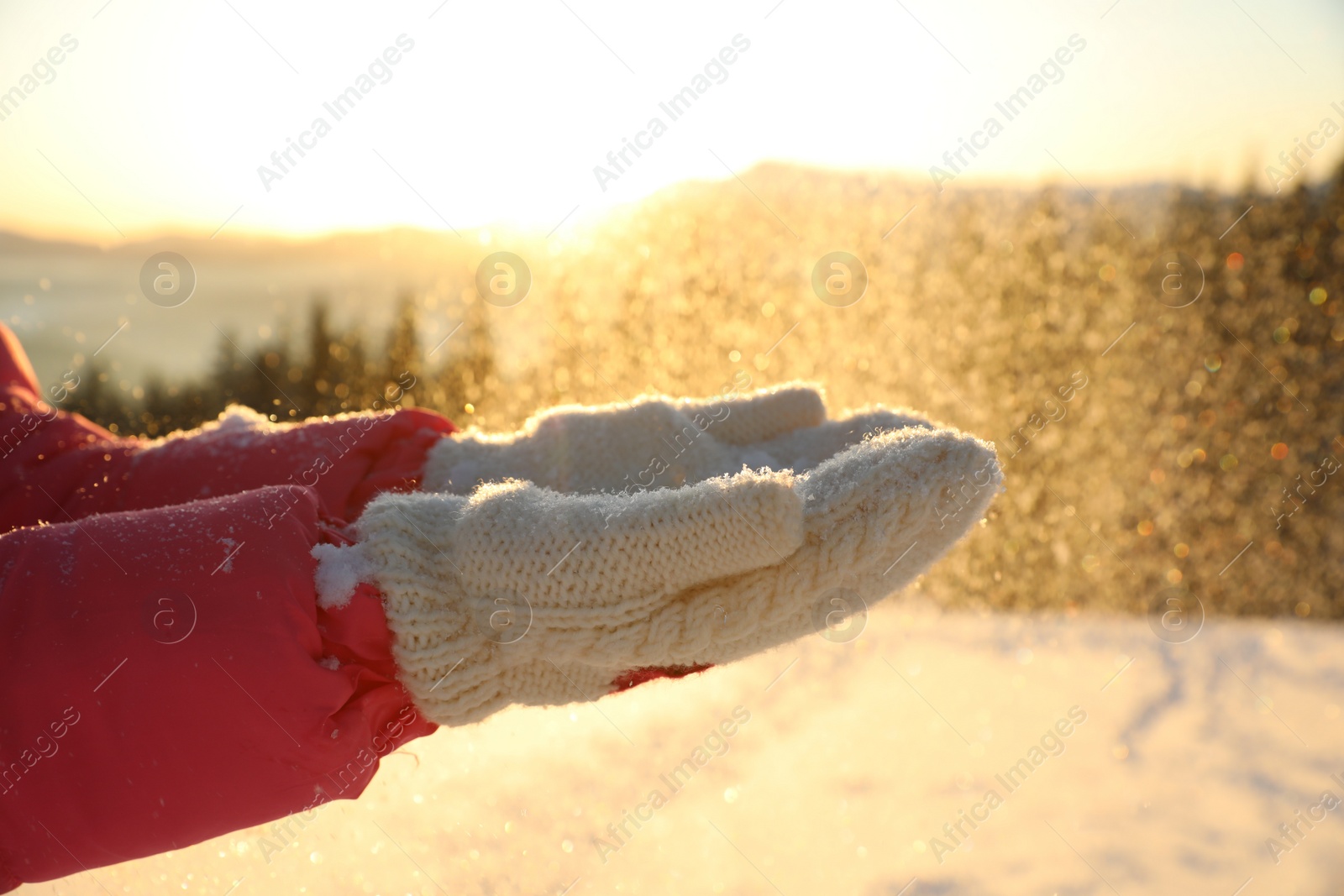 Photo of Young woman having fun outdoors on snowy winter day, closeup