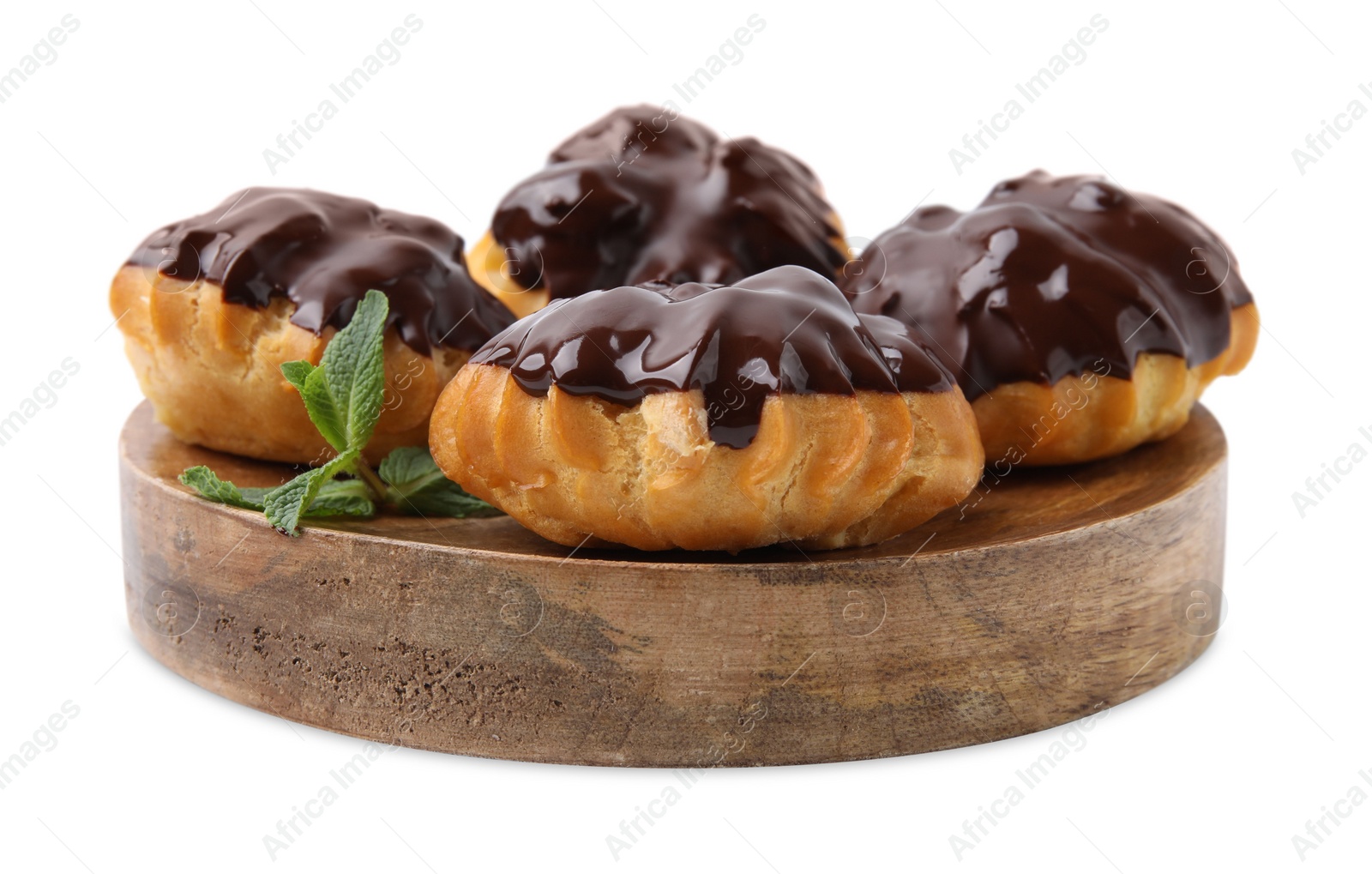 Photo of Delicious profiteroles with chocolate spread and mint isolated on white