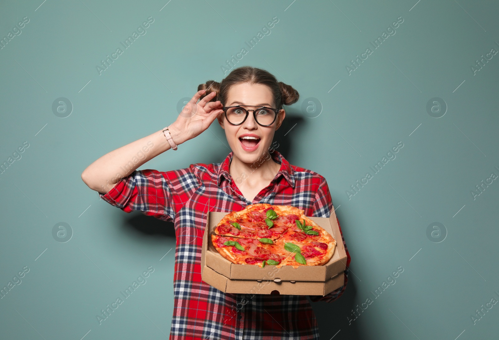 Photo of Attractive young woman with delicious pizza on color background