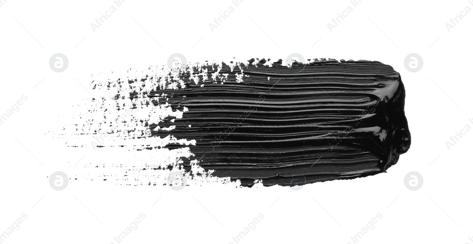 Photo of Brushstroke of black oil paint on white background, top view