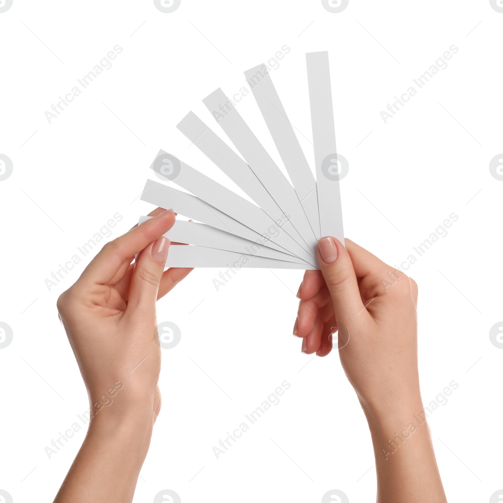 Photo of Woman holding perfume testing strips on white background, closeup of hands