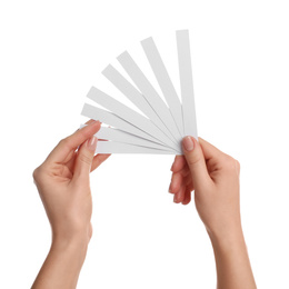 Photo of Woman holding perfume testing strips on white background, closeup of hands