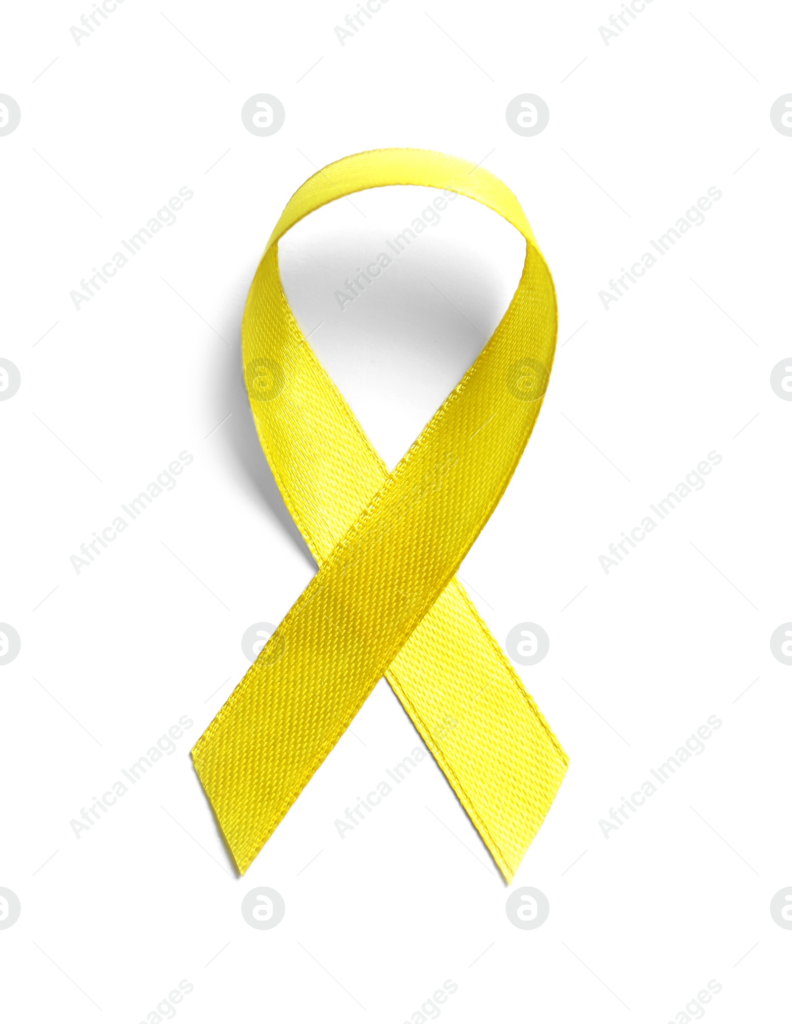 Photo of Yellow ribbon on white background, top view. Cancer awareness