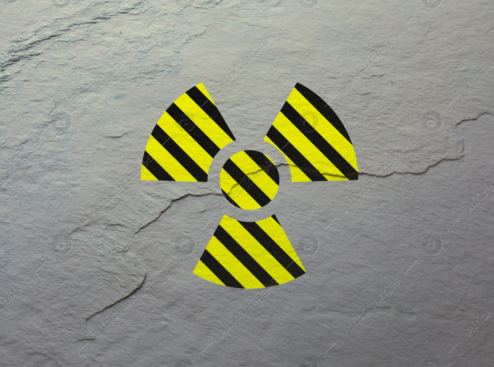 Image of Radioactive sign on light stone wall. Hazard symbol