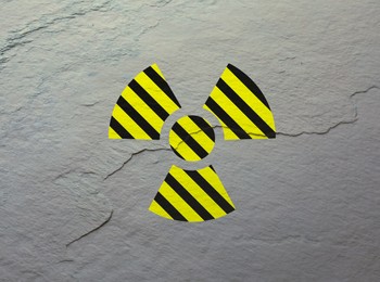 Image of Radioactive sign on light stone wall. Hazard symbol