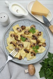 Photo of Delicious ravioli with ingredients on white wooden table, flat lay