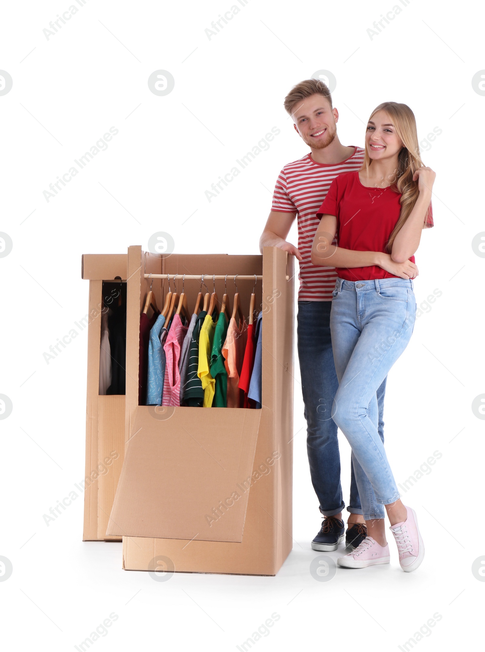 Photo of Young couple near wardrobe boxes on white background