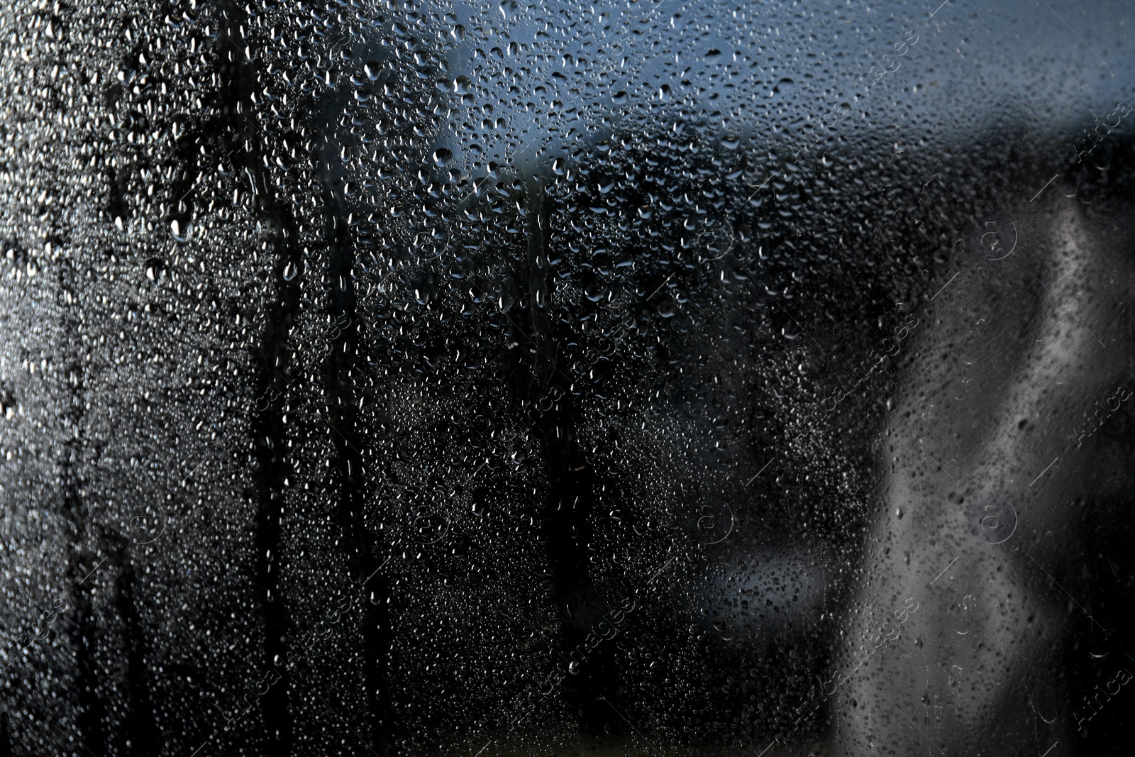 Photo of Rain drops on window glass as background