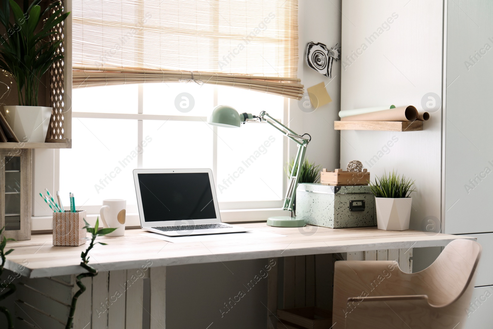 Photo of Modern home workplace with wooden crates. Eco style interior