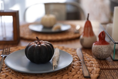 Photo of Wooden table decorated for Halloween in kitchen