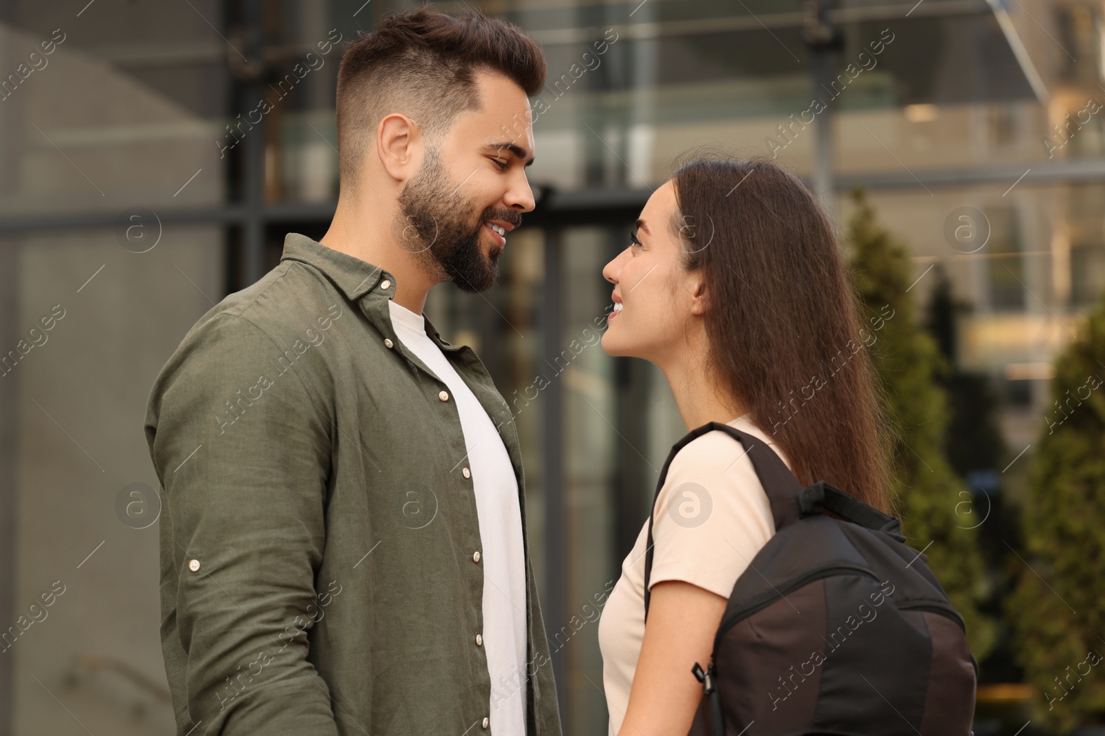 Photo of Long-distance relationship. Beautiful young couple with backpack outdoors