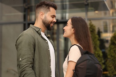 Photo of Long-distance relationship. Beautiful young couple with backpack outdoors