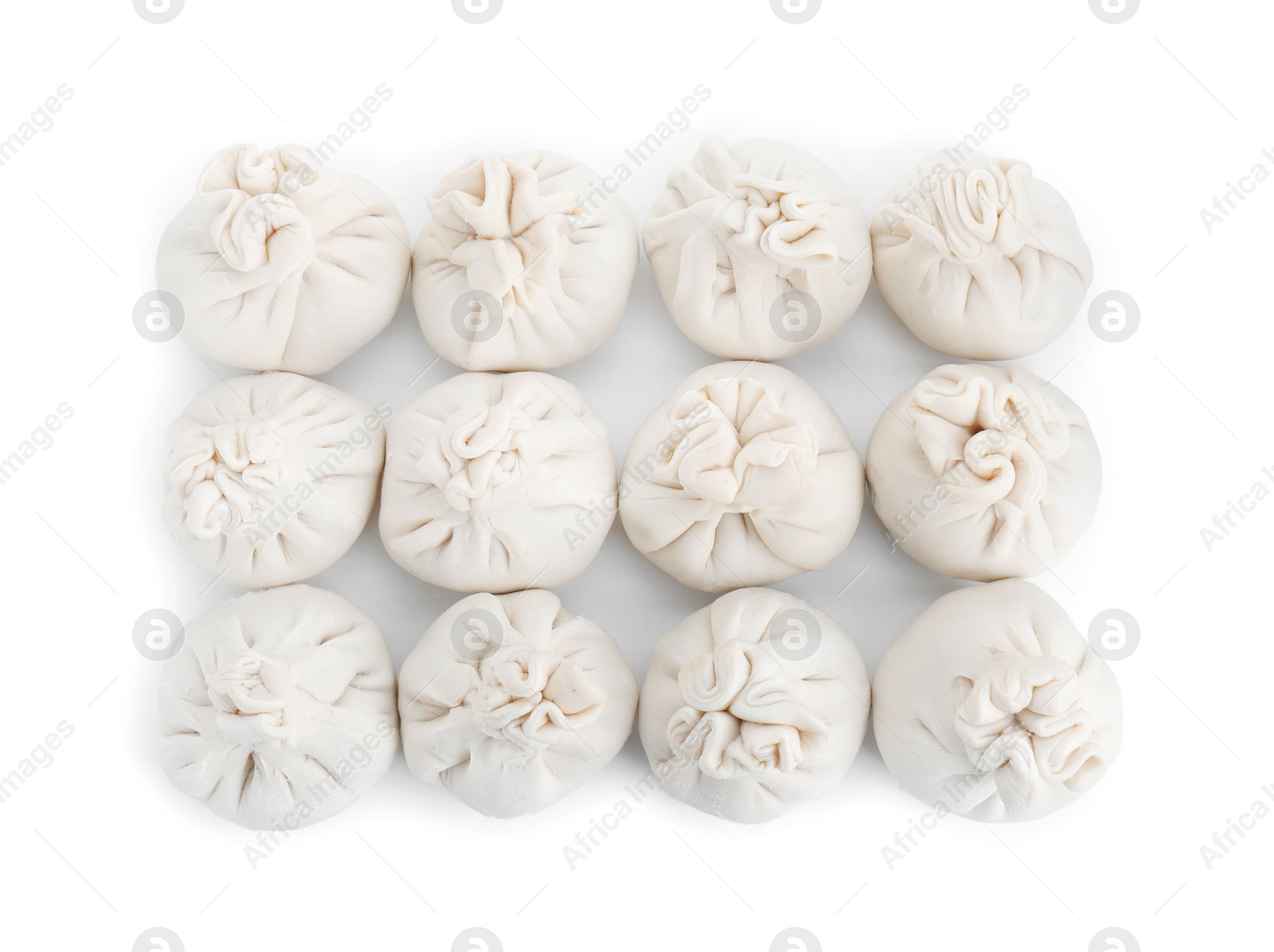 Photo of Many uncooked khinkali (dumplings) isolated on white, top view. Georgian cuisine