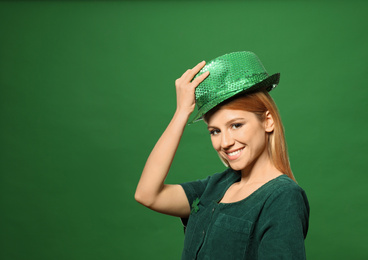 Photo of Young woman in green outfit on color background, space for text. St. Patrick's Day celebration