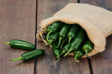 Photo of Sack with jalapeno peppers on wooden table