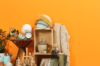 Photo of Many different items near orange wall. Garage sale