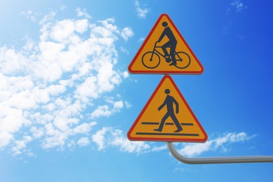 Photo of Signpost with Pedestrian Crossing Ahead and Cycle Route against clear sky, space for text