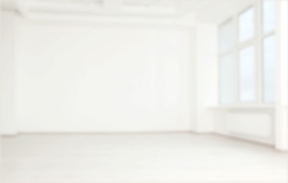 Image of Empty room with white wall and window, blurred view