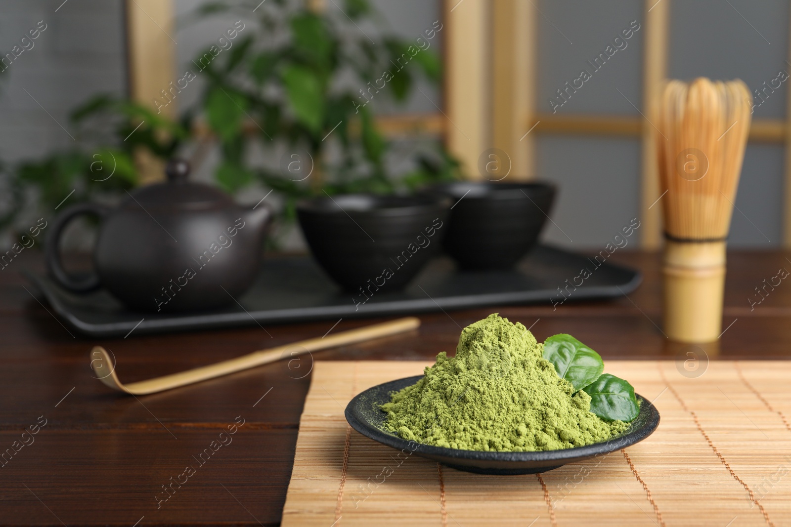 Photo of Plate with green matcha powder on wooden table indoors, space for text