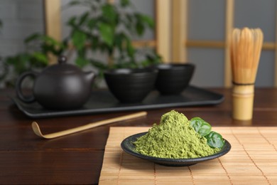 Photo of Plate with green matcha powder on wooden table indoors, space for text