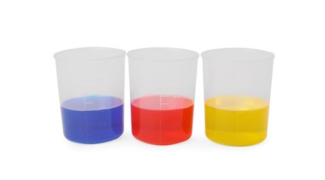 Photo of Beakers with colorful liquids isolated on white. Kids chemical experiment set