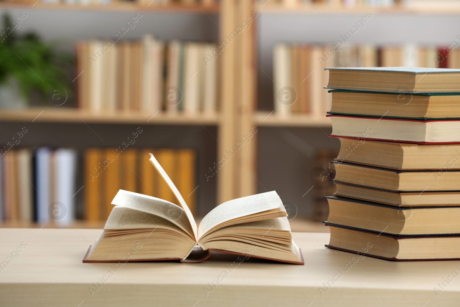 Photo of Many books on wooden table in library