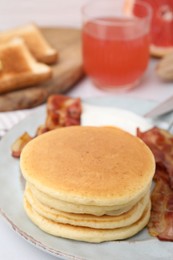 Photo of Plate with tasty pancakes on table, closeup