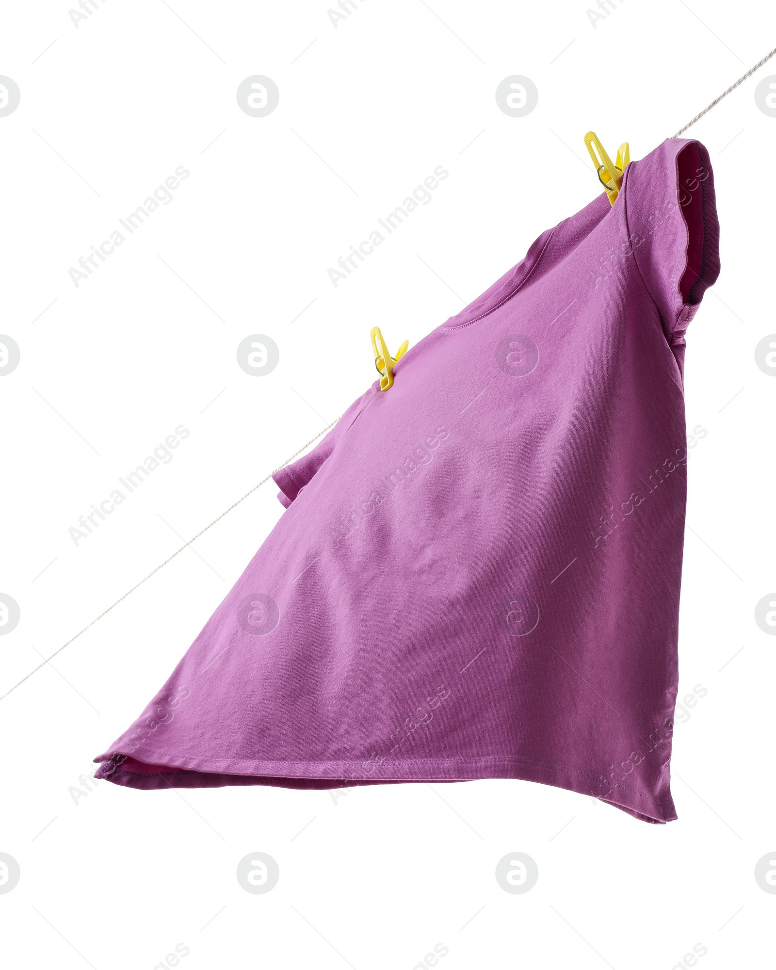 Photo of One violet t-shirt drying on washing line isolated on white