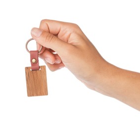 Woman holding wooden keychain on white background, closeup