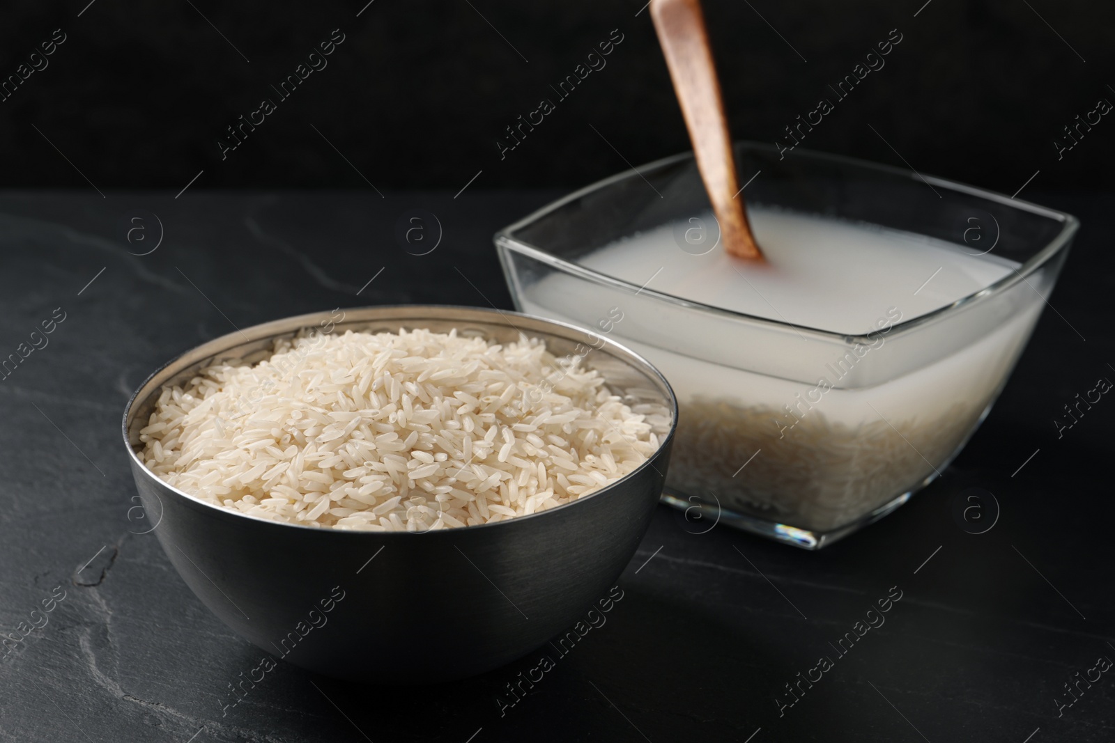 Photo of Rice soaked in water on black table