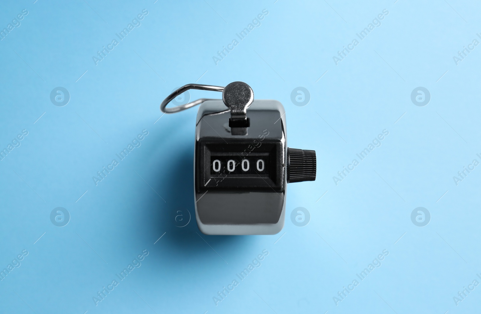 Photo of Modern timer on light blue background, top view