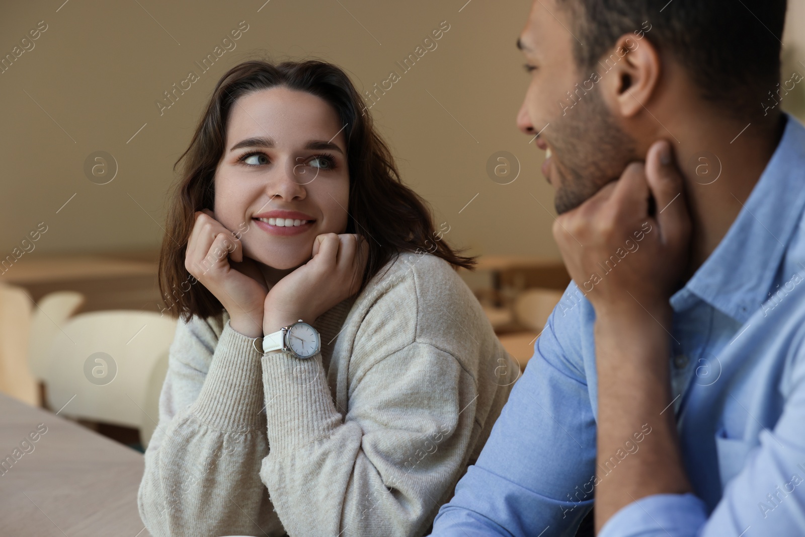 Photo of Romantic date. Happy couple spending time together indoors