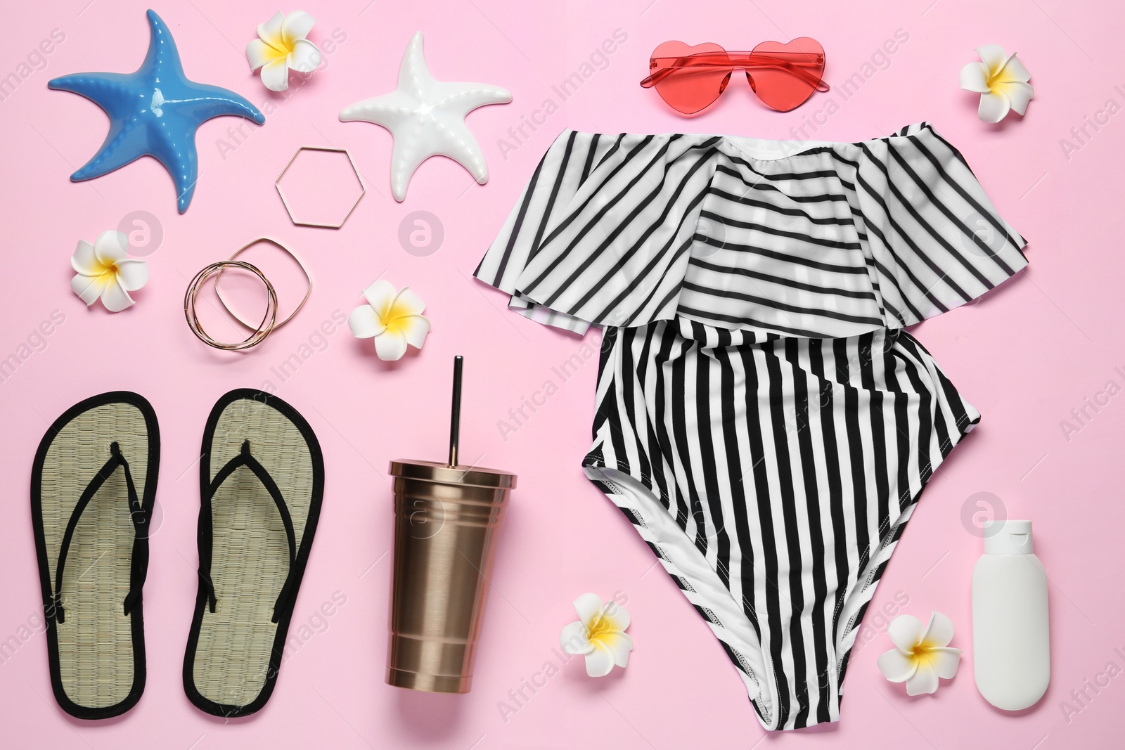 Photo of Flat lay composition with women's swimsuit on pink background