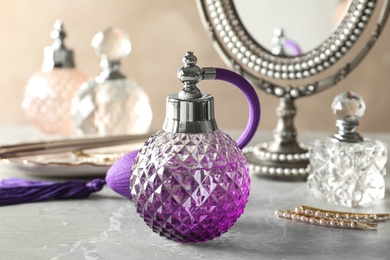 Photo of Different elegant perfume bottles on dressing table