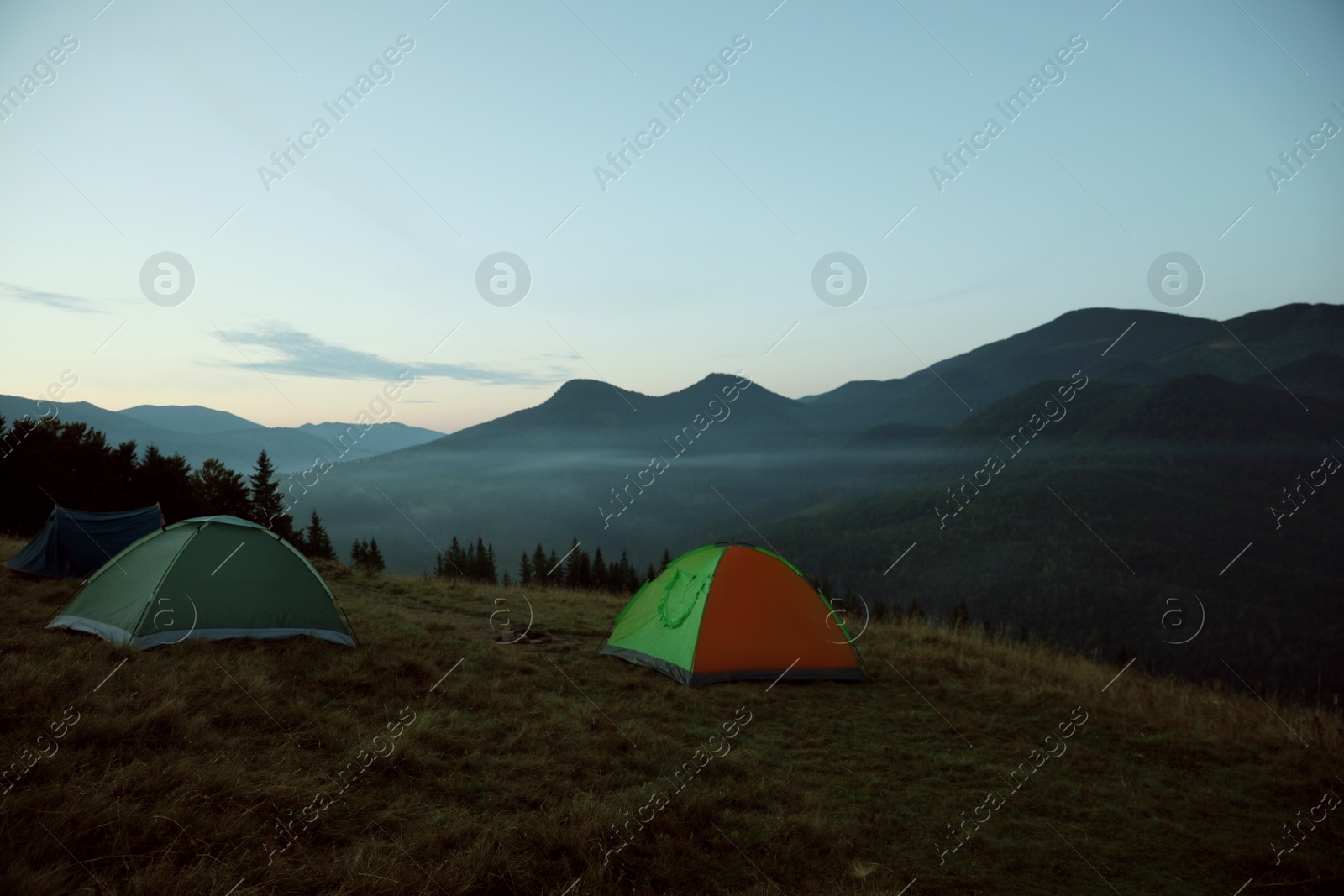 Photo of Camping tents on mountain slope in morning