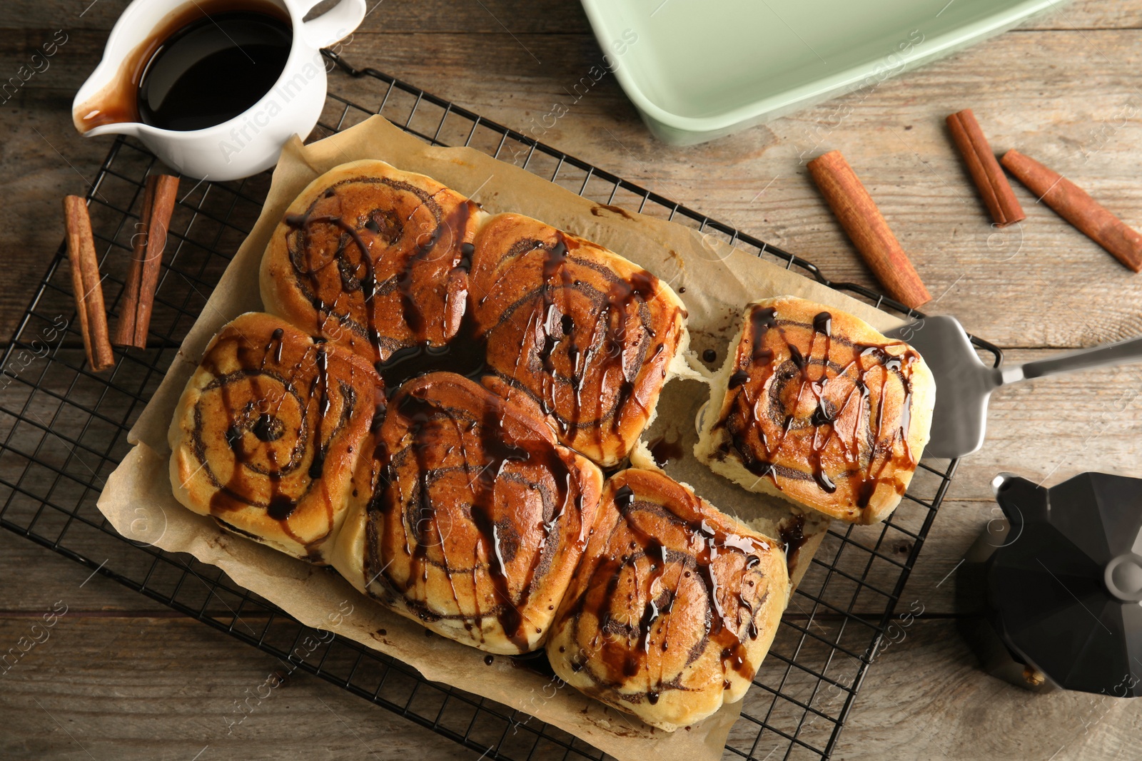 Photo of Flat lay composition with freshly baked cinnamon rolls on table