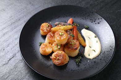 Delicious fried scallops on dark gray textured table, closeup