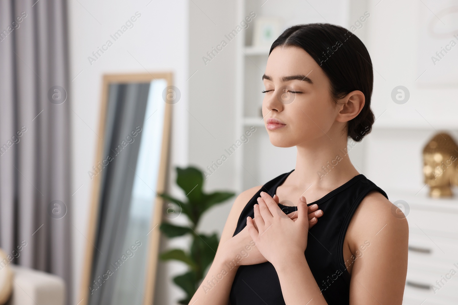 Photo of Beautiful girl meditating at home. Practicing yoga