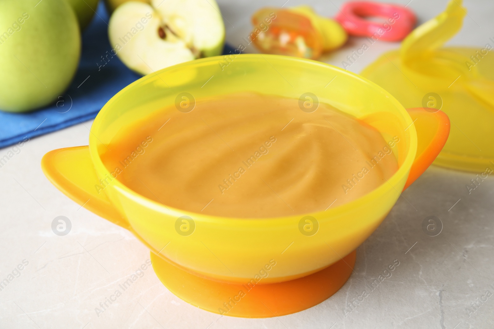 Photo of Bowl of healthy baby food on light table