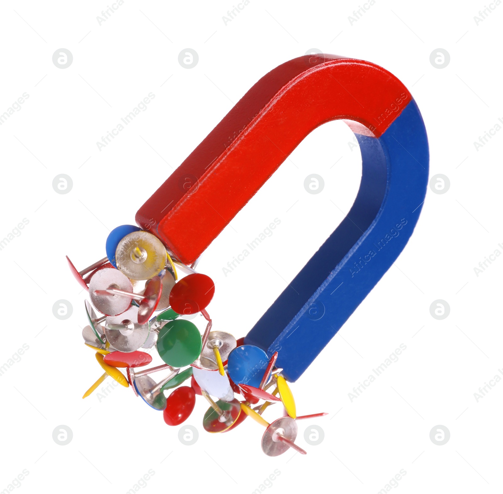 Photo of Horseshoe magnet attracting colorful drawing pins on white background