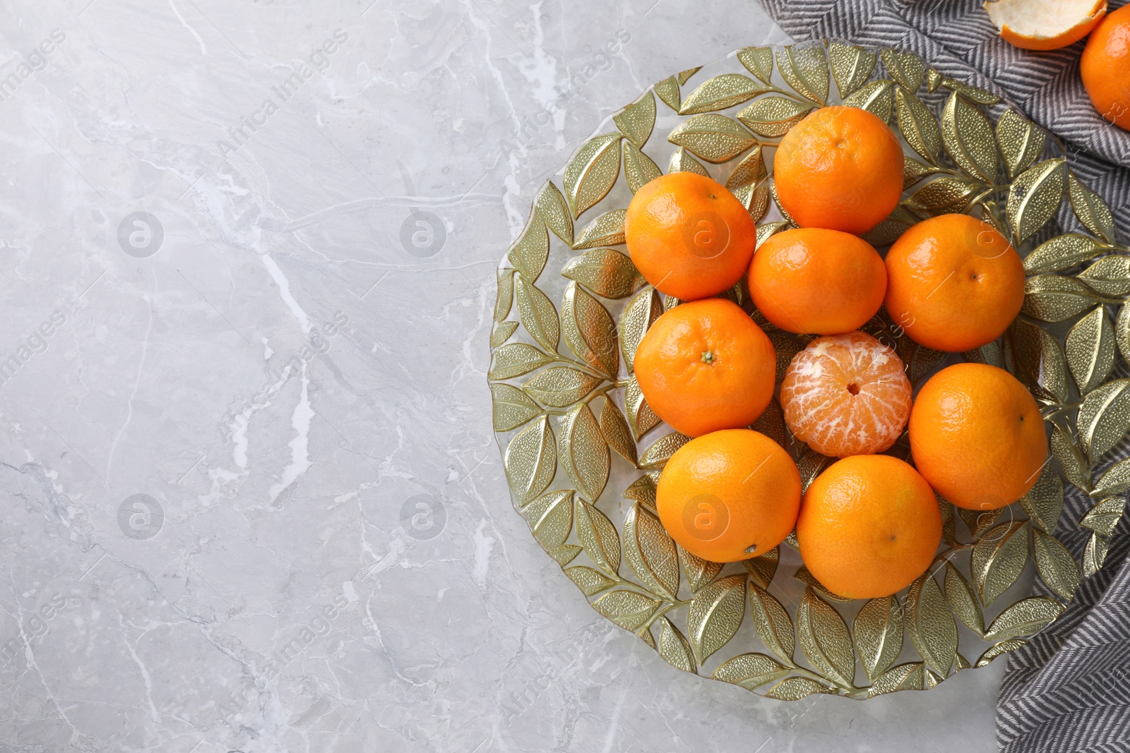 Photo of Fresh ripe tangerines on grey table, top view. Space for text