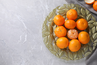 Photo of Fresh ripe tangerines on grey table, top view. Space for text