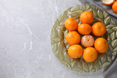 Fresh ripe tangerines on grey table, top view. Space for text