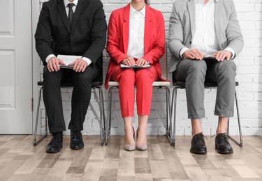 Photo of Group of people waiting for job interview, indoors