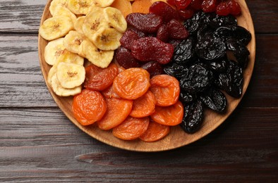 Delicious dried fruits on wooden table, top view