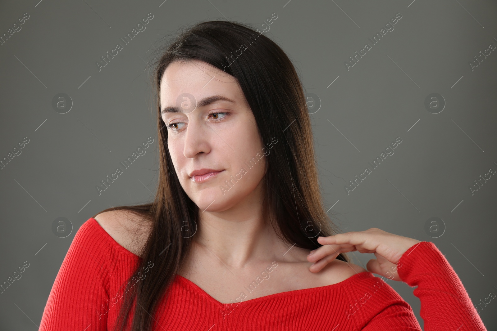 Photo of Portrait of beautiful young woman on grey background