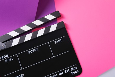 Photo of Clapperboard on color background, top view. Space for text