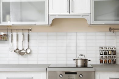 Photo of Modern kitchen interior with houseware and new furniture