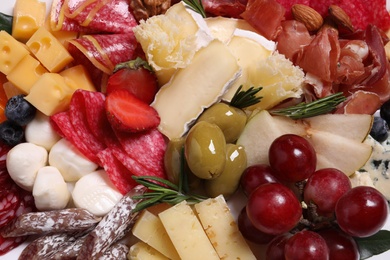 Photo of Different fresh appetizers as background, closeup view